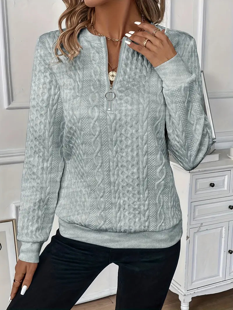 Sofia dames strikket trøje komfortabel med klassisk kabelstrikmønster og lynlås ved halsen, designet til en behagelig pasform og et stilfuldt look, perfekt til både hverdag og afslappede anledninger.